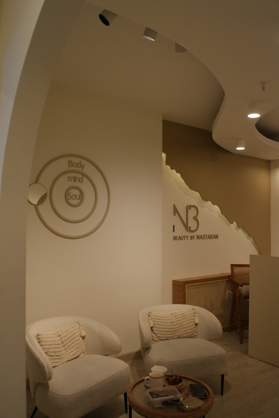 Comfortable armchairs in a bright beauty salon waiting area.