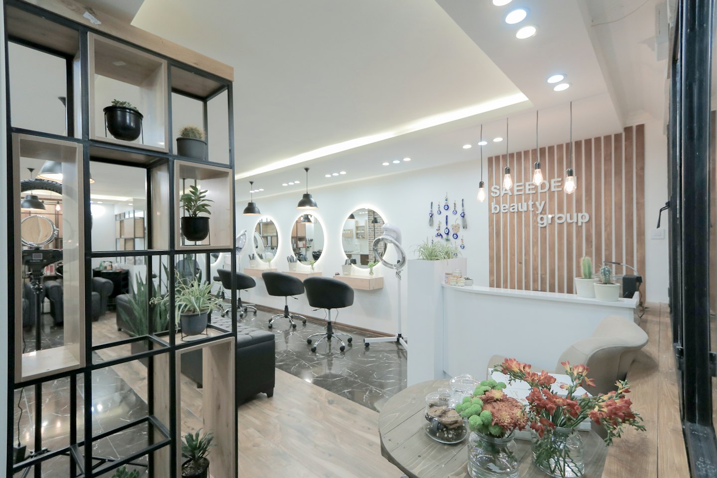 Modern salon with styling stations and reception desk.